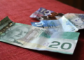 How many Canadians continue to use cash